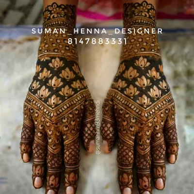 A full-hand design where the lotus is the star. The repeating pattern creates a bold, symmetrical look, and the dark stain makes the flowers truly stand out.