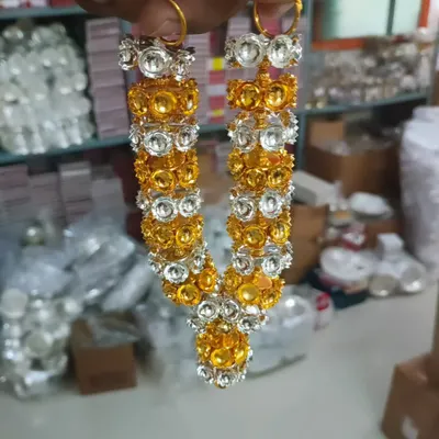 A beautiful haaram made of gold and silver colored stones. This garland is perfect for decorating deity photos or idols (Amma vaari alankarana).