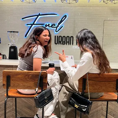 The BlackBx experience goes beyond the workout. Here are two members enjoying a laugh and a coffee at Fuel by Urban Fork.