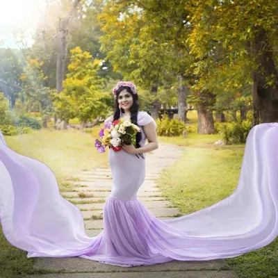 A beautiful maternity shoot in a park setting. I styled the mom-to-be in a flowing lavender gown with soft makeup to highlight her pregnancy glow, creating a serene and magical portrait.