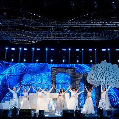 A wide view of one of our grand stage setups. This production featured a massive trussing rig for lighting, a custom LED screen with animated graphics, and large set pieces like the tree and archway to create a complete visual world.