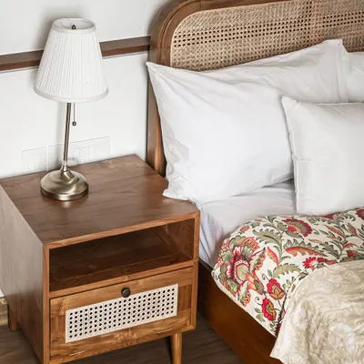 I am happy to see my custom bed and 'Koshi' side table gracing a client's home. The bed features a beautiful teak frame with a high rattan headboard.