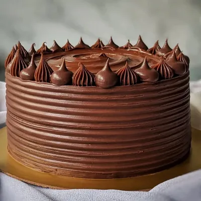 You can never go wrong with a classic chocolate cake. This one is covered in rich, dark chocolate ganache with a simple but elegant piped border.