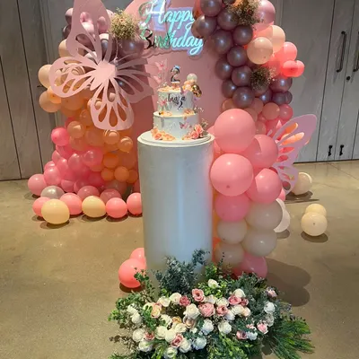 Here is the complete setup for Inaara's 2nd birthday, featuring the cake as the centerpiece. The combination of the backdrop, balloons, and floral arrangements creates a perfect photo opportunity.