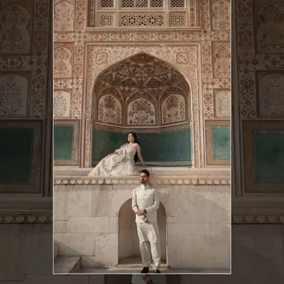 A majestic shot at Amer Fort in Jaipur, where the couple is framed by the intricate, historic architecture, showcasing the grandeur of a royal-themed pre-wedding shoot.