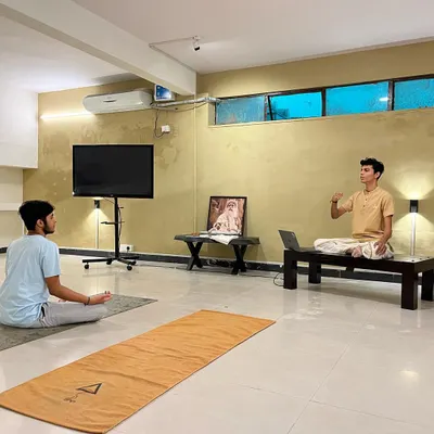 Guiding a participant through the subtleties of Surya Kriya. Each workshop focuses on providing precise, individual instruction to ensure the practice is learned correctly and safely.