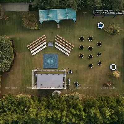 Our meticulous planning is visible from every angle. This aerial view reveals the precision of our event architecture, showcasing a symmetrical layout with designated zones for seating, performance, and guest interaction, ensuring optimal flow for a large-scale outdoor corporate event.