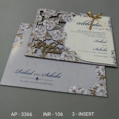 This invitation features a beautiful floral laser-cut cover over a grey background. The couple's names are also laser-cut from wood, adding a personalized and rustic element.