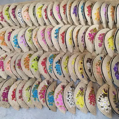 This image captures the beautiful variety in our collection of hand-embroidered clutches. Lined up, they showcase the range of colors and floral patterns available, all handcrafted by artisans. We can supply these in large quantities for retail or corporate gifting.