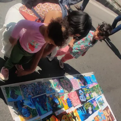 My collection of tiny paintings spread out at Chitra Santhe, attracting art admirers of all ages. These small canvases are a great way to start your art collection.
