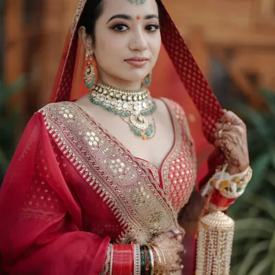 A close up portrait focusing on the bride's serene expression and exquisite jewelry. We use natural light to highlight the intricate details of the bridal look.
