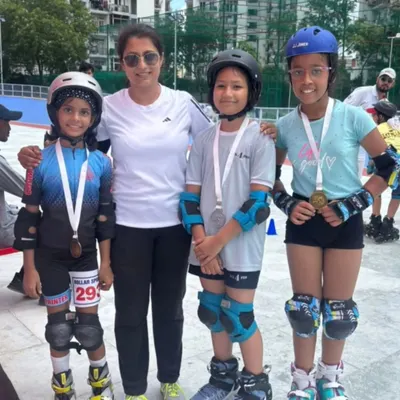 A proud coach with our decorated skaters after their success at the 2025 Interschool Skating Competition. Each medal represents countless hours of practice and perseverance.