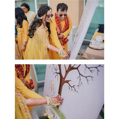A unique and personal touch at the Haldi ceremony. The couple and their family add their thumbprints to a "family tree" painting, a beautiful symbol of two families becoming one.