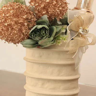 Our Moonlit Ivory Ceramic Vase, styled here with a festive arrangement. This timeless piece is a blank canvas, ready to adapt to any mood, from minimal to celebratory.
