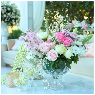 Every corner deserves a bloom. This elegant centerpiece features a mix of pink and white roses, stock flowers, and baby's breath in a crystal-cut vase.