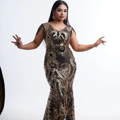 Own the spotlight in this stunning black and gold sequin mermaid gown. The intricate pattern and flattering silhouette are perfect for making a statement at any event.