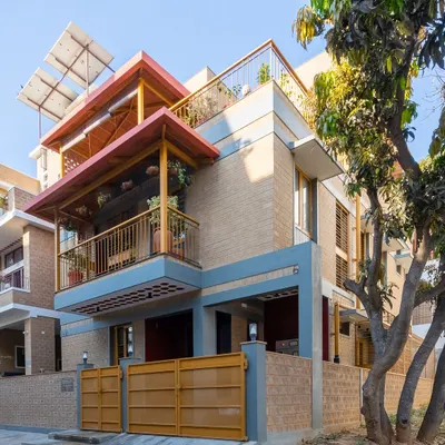 The Audumbara residence, seen from the street. The design features deep, shaded balconies, Mangalore tile roofing, and solar panels, all working together to create a climate-responsive home.
