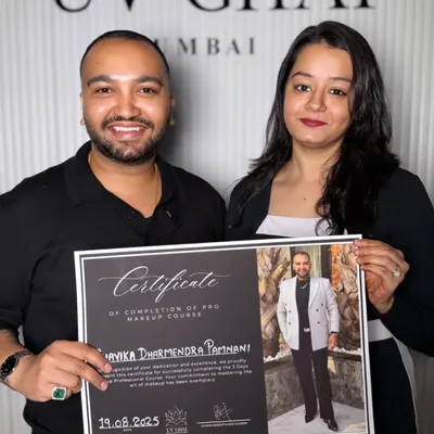 A photo of me receiving a certificate of completion for a pro makeup course from UV Ghai, showcasing my commitment to continuous learning.