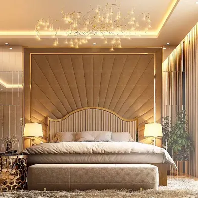 This master bedroom is the epitome of hotel-inspired luxury. A magnificent, full-wall headboard with a sunburst upholstery pattern and gold trim creates a breathtaking focal point, complemented by a cascading crystal chandelier.