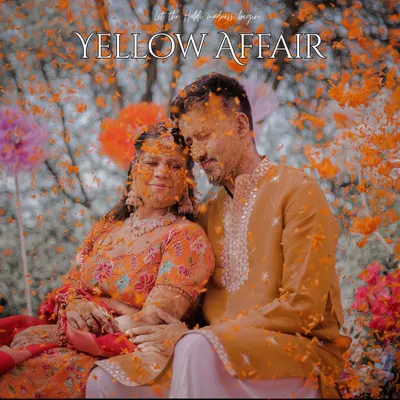 This is what a 'phoolon wali haldi' looks like. We love capturing the moment when the couple is showered in flower petals, creating a vibrant, joyful, and highly memorable image.