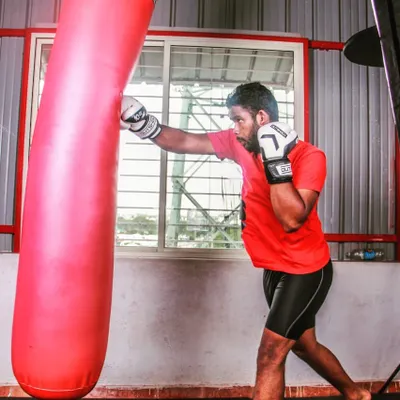 The heavy bag is essential for developing power and endurance. Here, a student at the academy practices his straight right, focusing on full extension and hip rotation to deliver a powerful, combat-ready punch.
