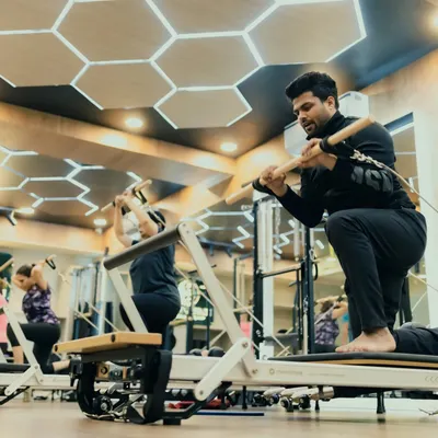 This client performs a deep stretch using the Reformer, working on flexibility and control. Regular stretching is key to keeping the body limber and injury-free.