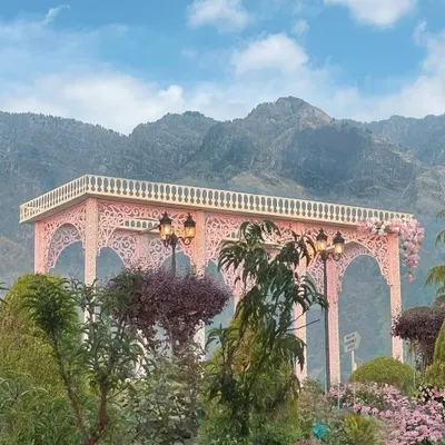 For this event in Kashmir, I designed a beautiful pink arched structure that perfectly framed the majestic mountain range in the background. The natural beauty of the location became an integral part of the decor.