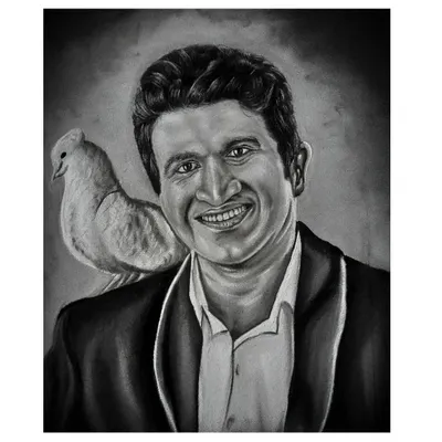 A tribute portrait of the late Kannada superstar Puneeth Rajkumar, known as 'Appu' to his fans. This artwork, made with charcoal and white stone powder, captures his warm smile and has been a meaningful piece for his admirers.