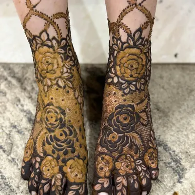 A stunning floral design for the feet, featuring bold roses that cover the top of the foot and extend up the ankle in a delicate vine. This is a perfect choice for a bride who loves floral motifs.