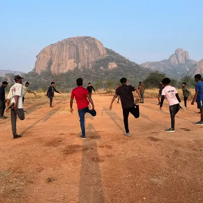 Every great climb starts with a proper warm-up. Participants in our basic course stretch against the iconic backdrop of Ramanagara's rock formations, preparing their bodies for the day's activities.