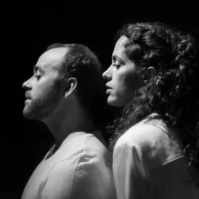 A dramatic black and white portrait of the duo from 'Little Italy'. This artistic shot captures the intense connection and shared focus between the soprano and the accordionist during their performance.