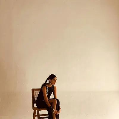 A minimalist fashion shot with a focus on silhouette and attitude. I styled this simple black dress with bold, stacked bracelets and a sleek hairstyle, using negative space in the composition to create a modern and edgy portrait.