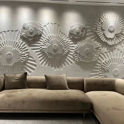 A living room wall brought to life with a custom 3D floral mural from our 'Layers' collection by World of Stones. The deep carvings create dramatic shadows, making the wall a dynamic focal point.