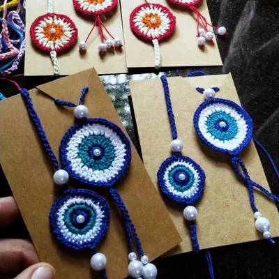 Our evil eye rakhi and lumba sets are a modern take on a beautiful tradition. Each set is handmade and includes pearl details for an elegant finish.