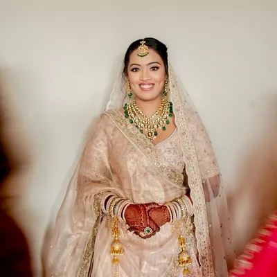 There is unmatched beauty in minimalism. For this bride's ivory lehenga, we chose a fresh, radiant look rooted in elegance, combining soft glam with a hint of tradition for a glow that shines in every frame.