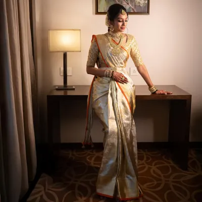 Our bride Hima looking absolutely radiant for her muhurtham. I designed the hand-embroidered blouse to match her stunning gold tissue Kanjeevaram saree, creating a look of pure elegance.