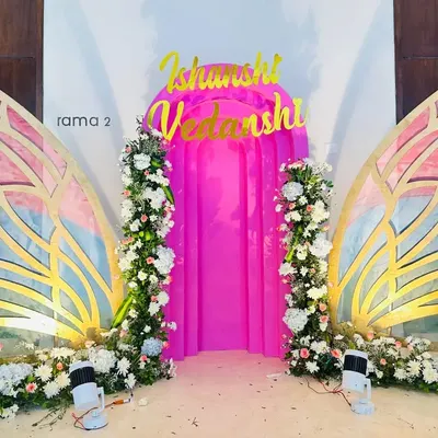 These large, custom-built butterfly wings serve as a unique, interactive photo backdrop. Decorated with artificial flowers and featuring a pink curtained entrance, they create a magical photo opportunity.