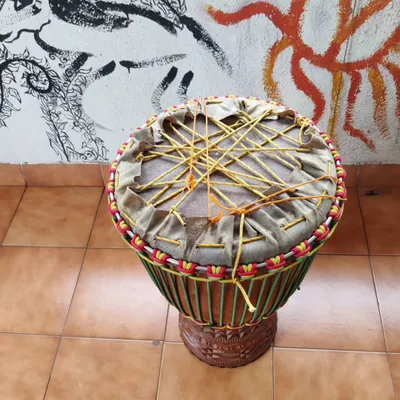 The 'dry pull' is a critical step in the djembe building process. I use a complex web of ropes to apply even, immense pressure on the new skin, stretching it over the shell. This is pure physical effort and meditation for me.