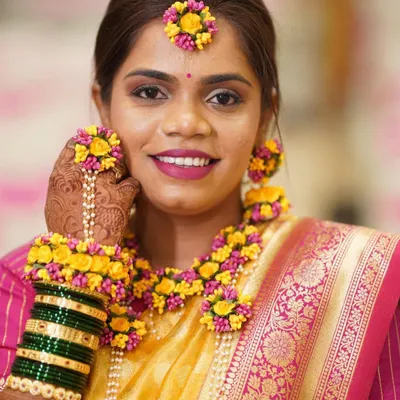 A radiant Haldi bride ready for her ceremony. I created a soft, glowing makeup look and she paired it with beautiful fresh floral jewelry.