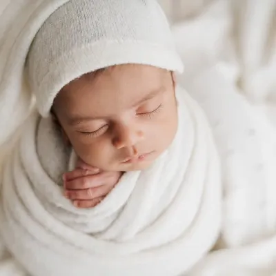 There's nothing more classic than a baby in all white. Swaddled snugly with a little sleepy hat, this portrait is pure, simple, and timeless.