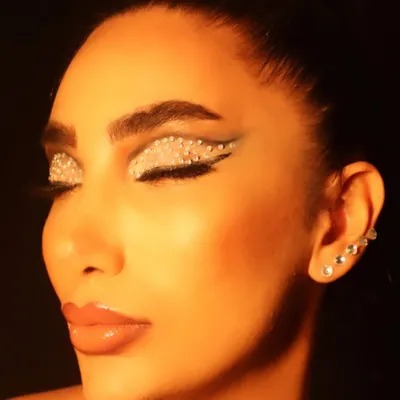 This rhinestone eye makeup is pure creativity. I love experimenting with different textures and materials to create unique, conceptual looks like this one.