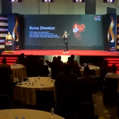 Performing on a grand stage for a corporate summit. The combination of professional lighting, large screen visuals, and my act creates a powerful and immersive experience for every attendee.
