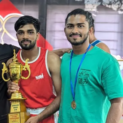 Celebrating victory. Two of my dedicated fighters showcasing the trophy and medal they earned through hard work and discipline at an interclub competition.