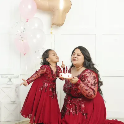 A mother and daughter celebrating a birthday together. Capturing this bond in matching dresses creates a memory that both will treasure forever.
