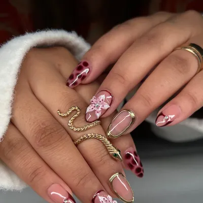 A mixed-media set showcasing my hand-painted skills. This look combines a delicate floral design, a trendy tortoiseshell pattern, and a negative space nail with a gold chrome border.