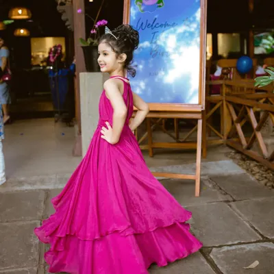 This custom magenta birthday gown was designed to be a showstopper. The layered skirt adds volume and movement, while the simple, elegant bodice and halter neck keep it comfortable for a full day of celebration.