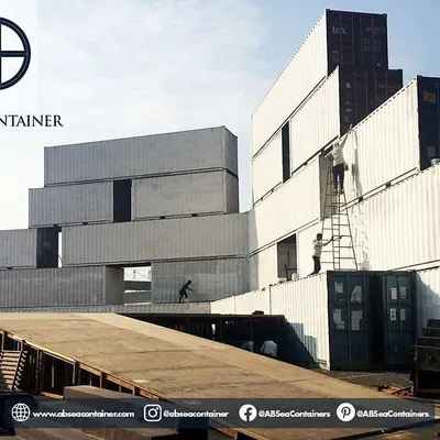 This image shows the assembly of a massive, multi-story container structure for an event at the Buddh International Circuit. Our team is experienced in stacking and securing containers for large, temporary installations.