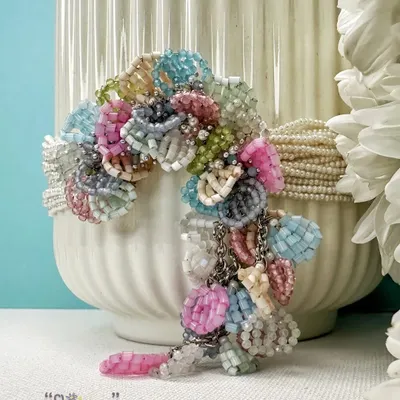This is our classic FLORAA choker, handcrafted with a rainbow of beautiful pastel beads. It's a versatile piece designed to steal the show and add a playful touch to your festive or wedding guest look.