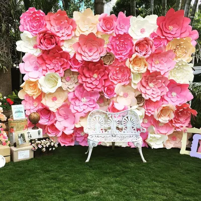I created this stunning paper flower wall as a photo backdrop for a travel-themed baby shower. The wall is densely packed with handmade paper flowers in shades of pink, rose, and cream, providing a beautiful and memorable spot for guests to take pictures.