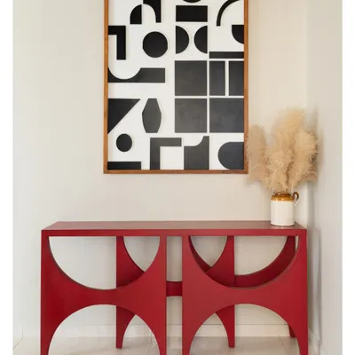 This bright red console table makes a bold statement in the foyer of our Devanahalli project, set against a custom black and white geometric art piece. It’s an unexpected pop of color that welcomes you into the home.